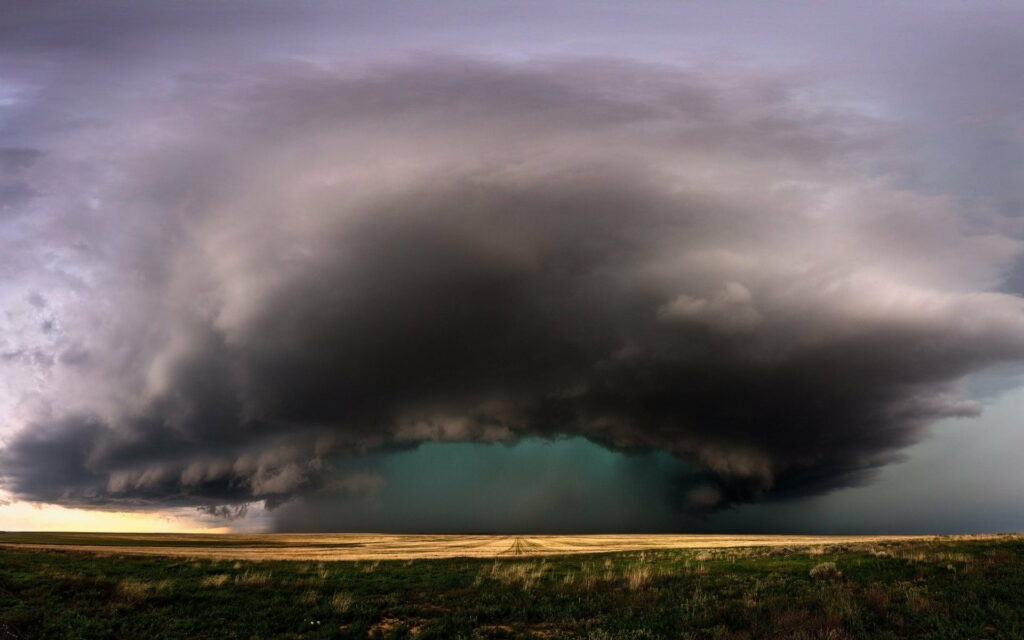 Dramatic HD Wallpaper: Ominous Storm Clouds Over Open Field