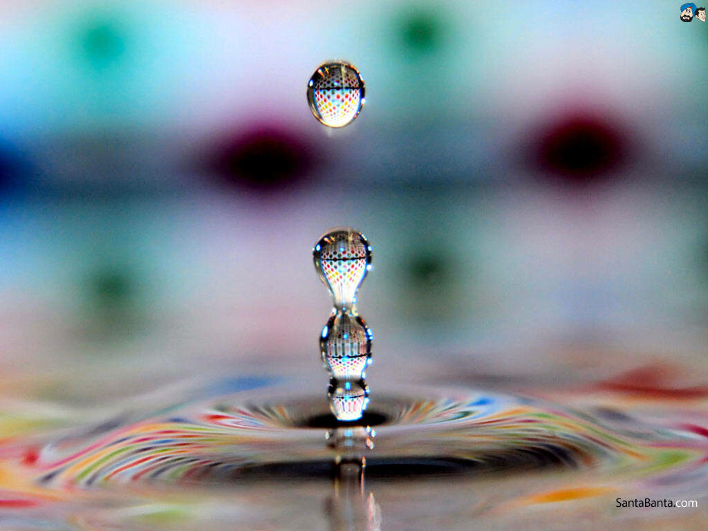 Vibrant HD Water Droplets Wallpaper on Reflective Surface