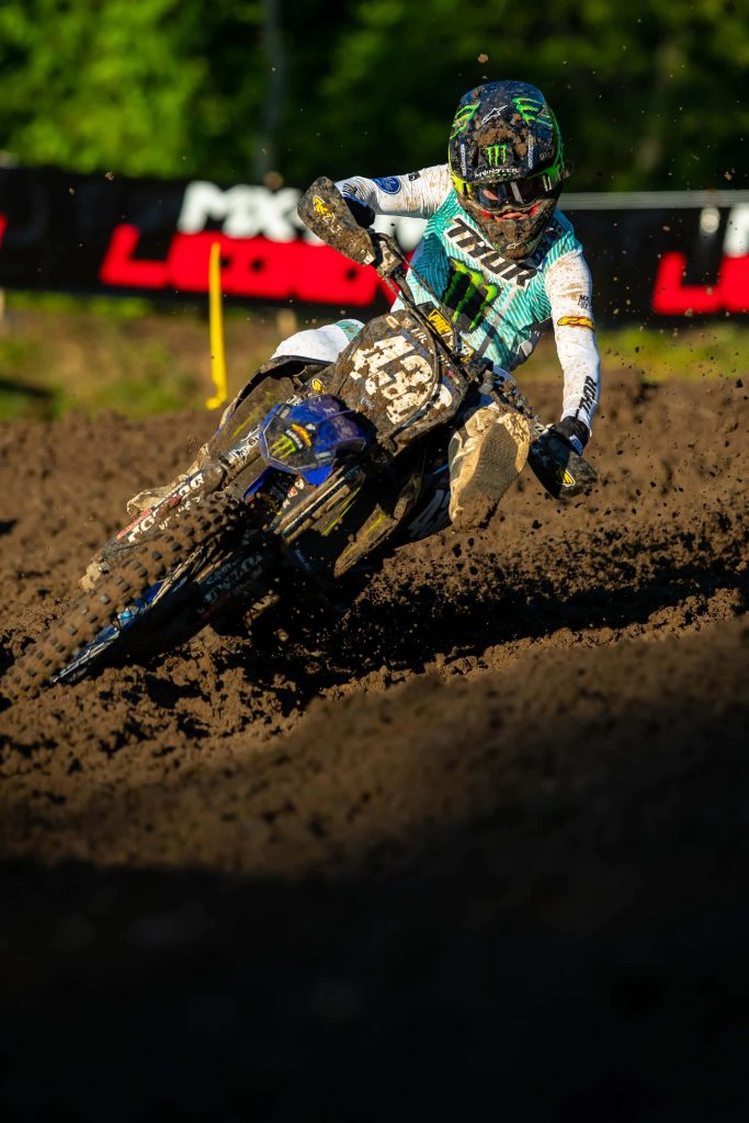 Haiden Deegan motocross rider leans into muddy corner in high contrast Monster Energy Yamaha race Wallpaper