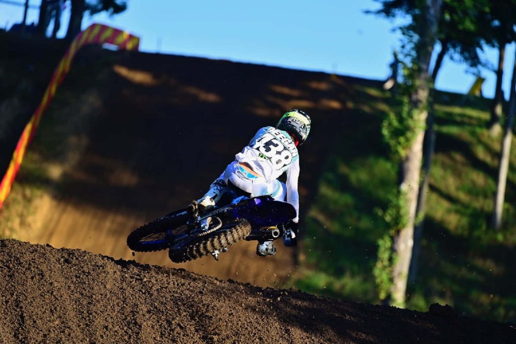 Motocross star Haiden Deegan number 38 airborne on dirt bike at sunny outdoor track wallpaper