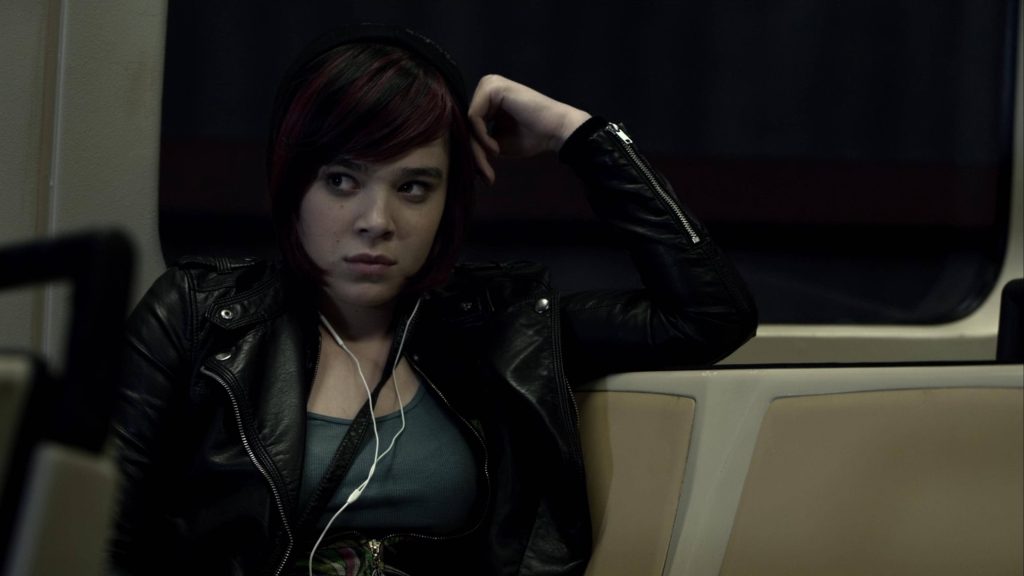 Hailee Steinfeld as Megan Walsh in Barely Lethal wearing leather jacket on dim train wallpaper