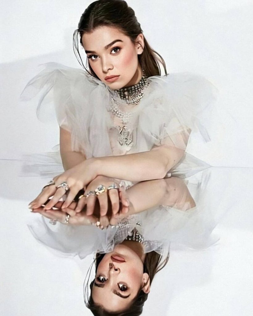 Studio portrait of Hailee Steinfeld in ruffled white top with ethereal mirror reflection effect Wallpaper