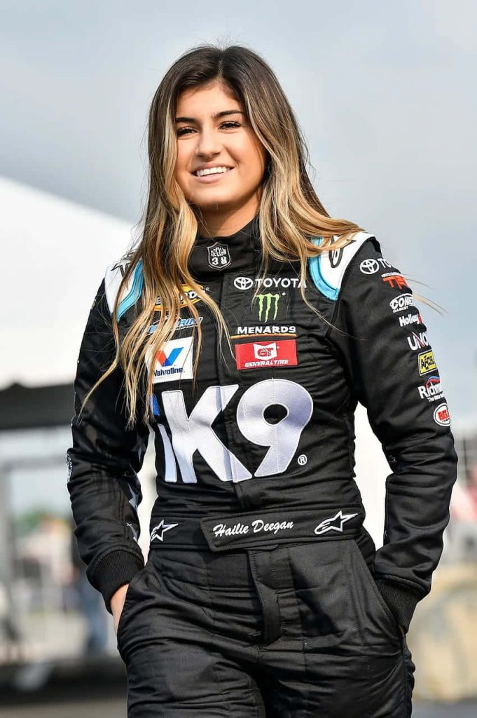 NASCAR driver Hailie Deegan in black racing suit with Toyota and K9 sponsor patches portrait Wallpaper