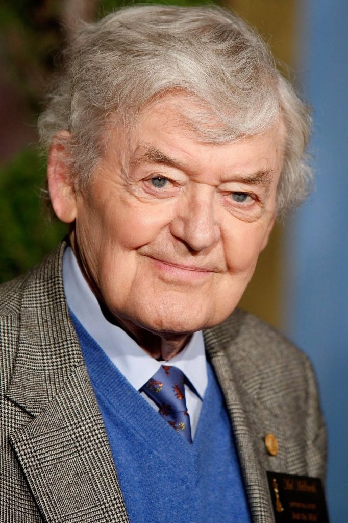Portrait of Hal Holbrook smiling in blue sweater checkered coat with soft professional lighting Wallpaper