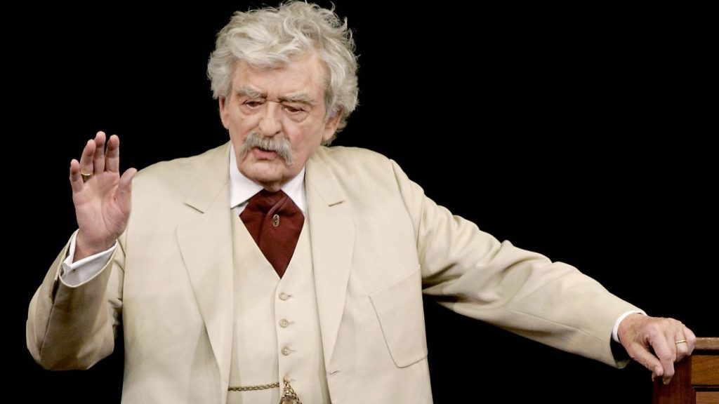 Hal Holbrook as Mark Twain in white suit iconic storyteller pose black background wallpaper