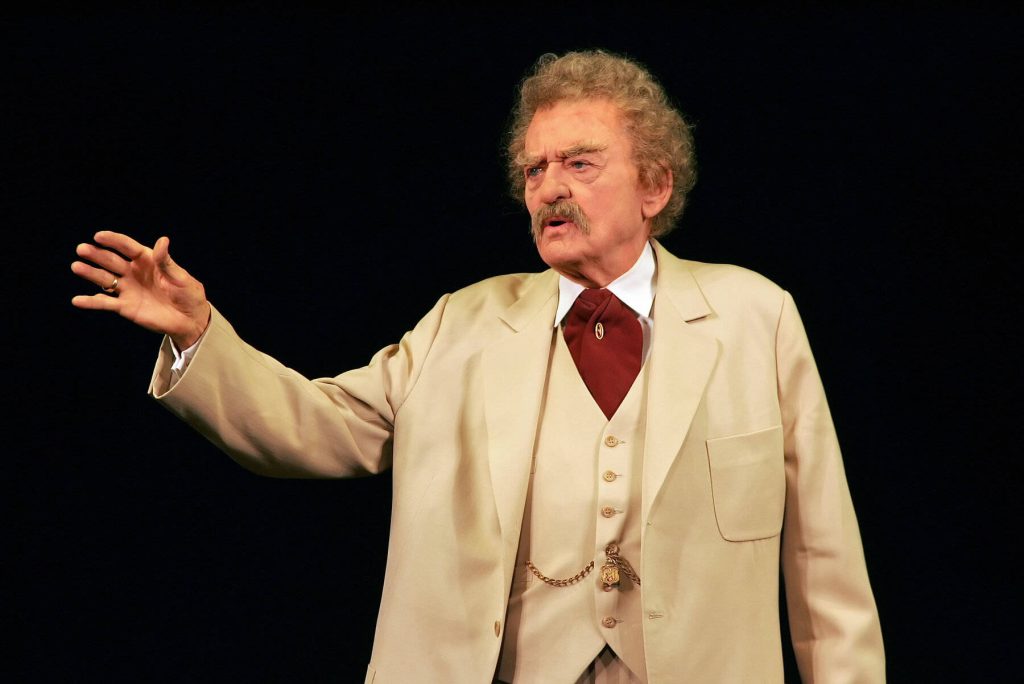 Hal Holbrook as Mark Twain in cream suit and red cravat high contrast portrait wallpaper