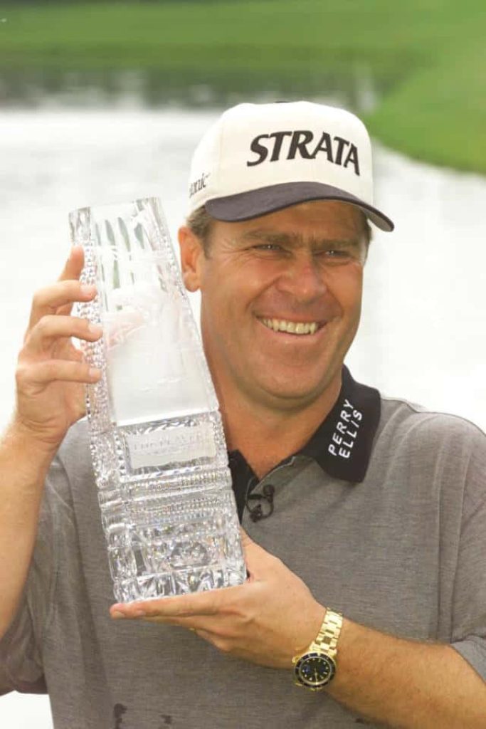 Hal Sutton holding The Players Championship trophy wearing Strata cap and Perry Ellis polo Wallpaper