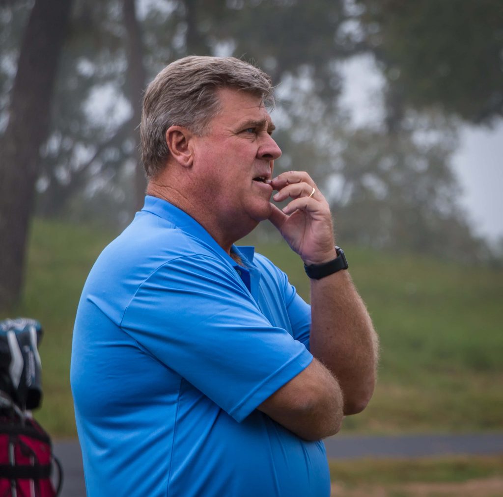 Professional golfer Hal Sutton in blue polo on misty golf course focused wallpaper background