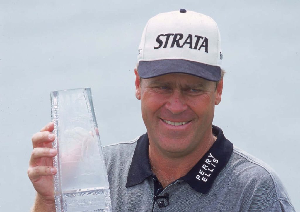 Hal Sutton celebrating golf victory holding tall glass trophy in grey Perry Ellis polo and white cap Wallpaper