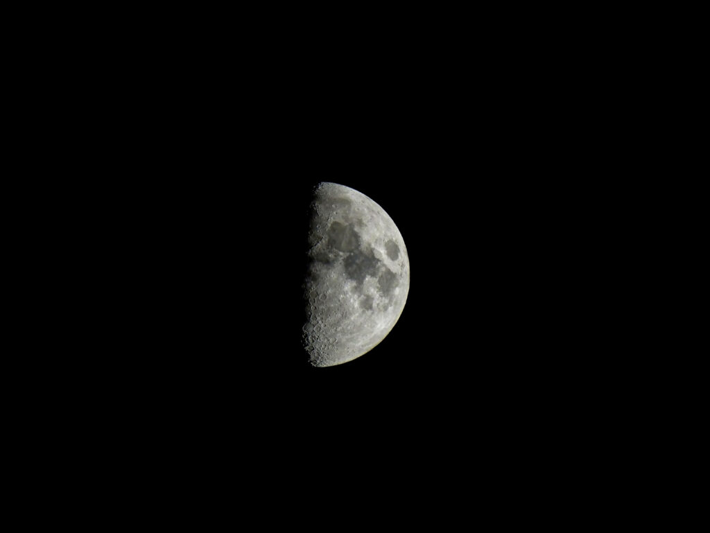 Half-Moon Wallpaper: Minimalist Design with Lunar Craters on Black Sky