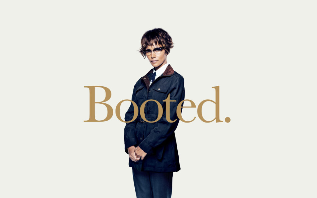 Halle Berry as Kingsman character confident pose gold Booted text stylish modern wallpaper background