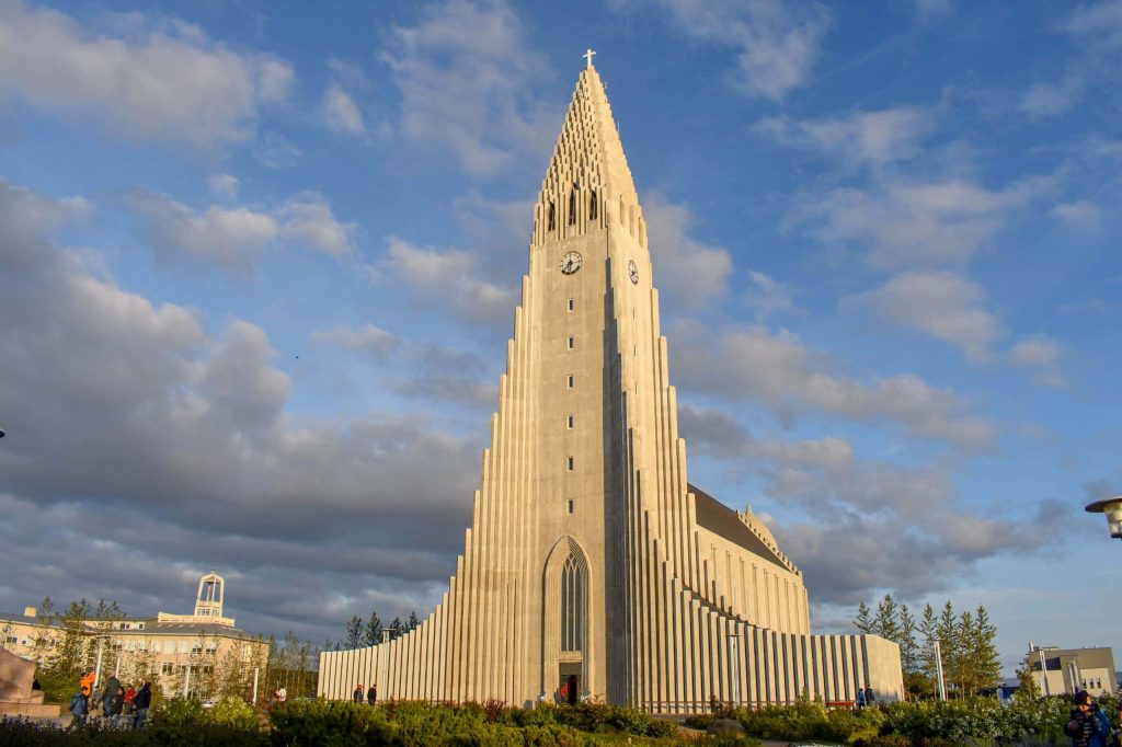 Hallgrímskirkja church Reykjavik Iceland sunlight blue sky expressionist architecture tall Wallpaper