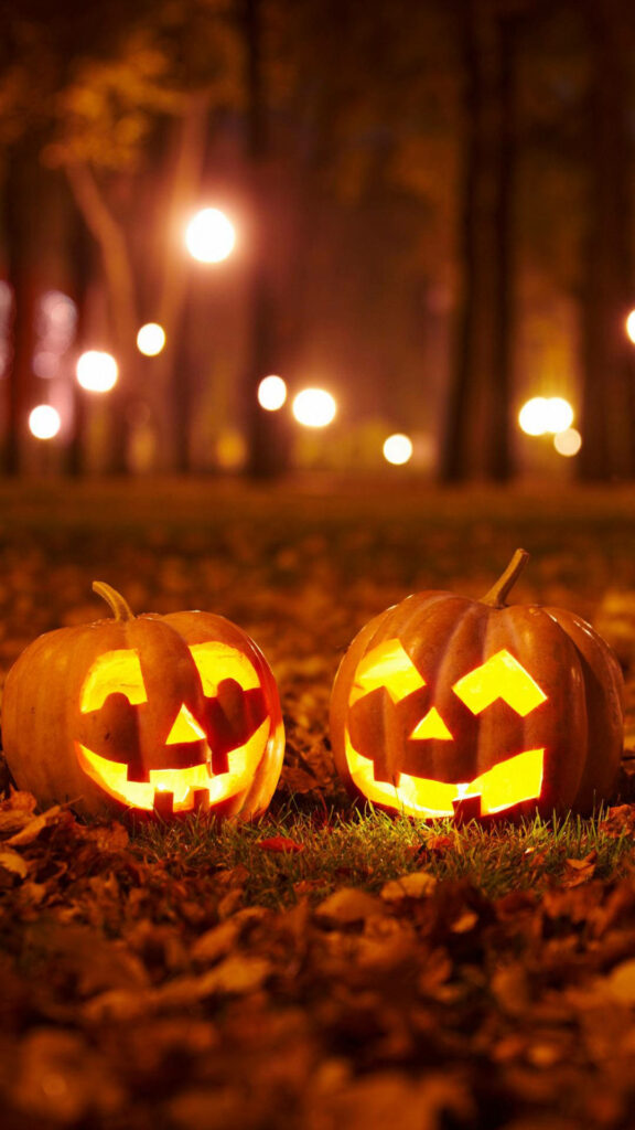 Enchanted Autumn Encounter: Pumpkins Unite in a Spooky Forest - Halloween Themed Phone Background Wallpaper