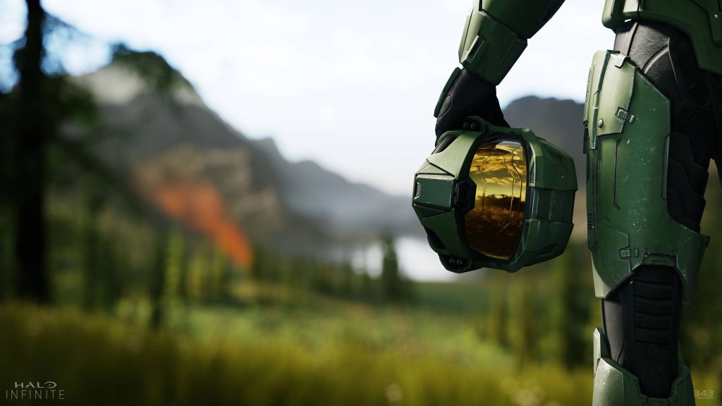 Master Chief in Halo Infinite forest at sunset holding helmet cinematic gaming wallpaper background
