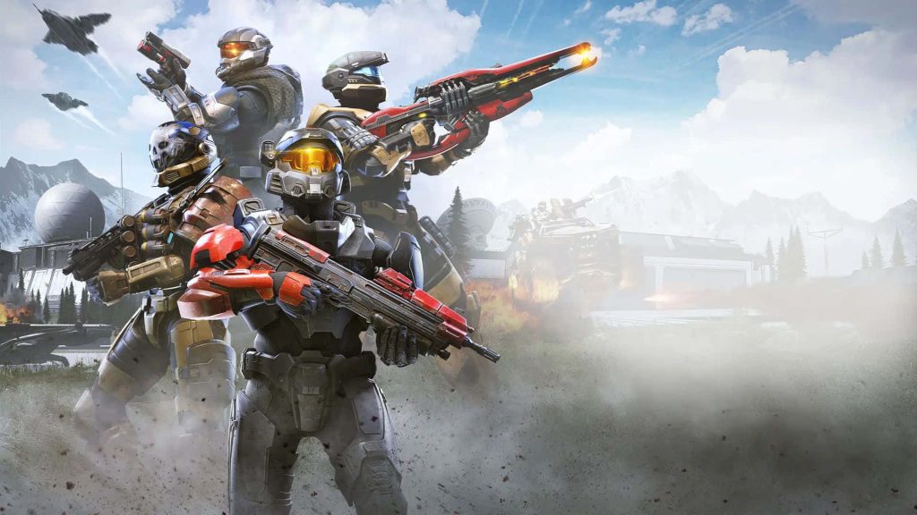 Four armored Spartans ready for battle with rifles in a misty Halo Infinite mountain scene wallpaper