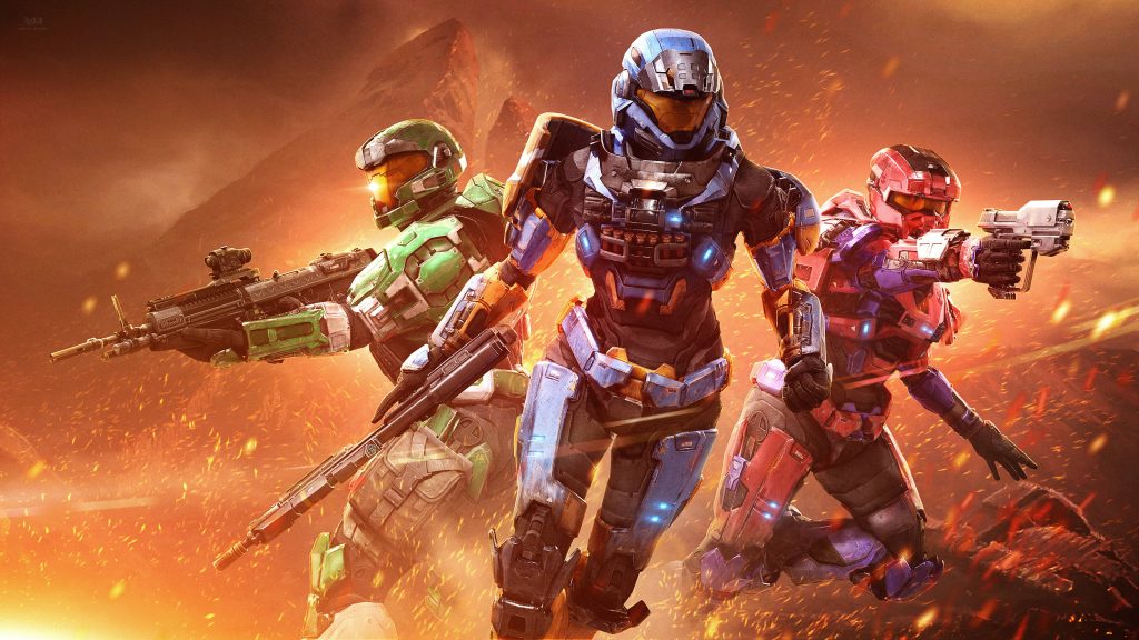 Halo Infinite wallpaper with three armored Spartans in vibrant armor on ember battlefield background