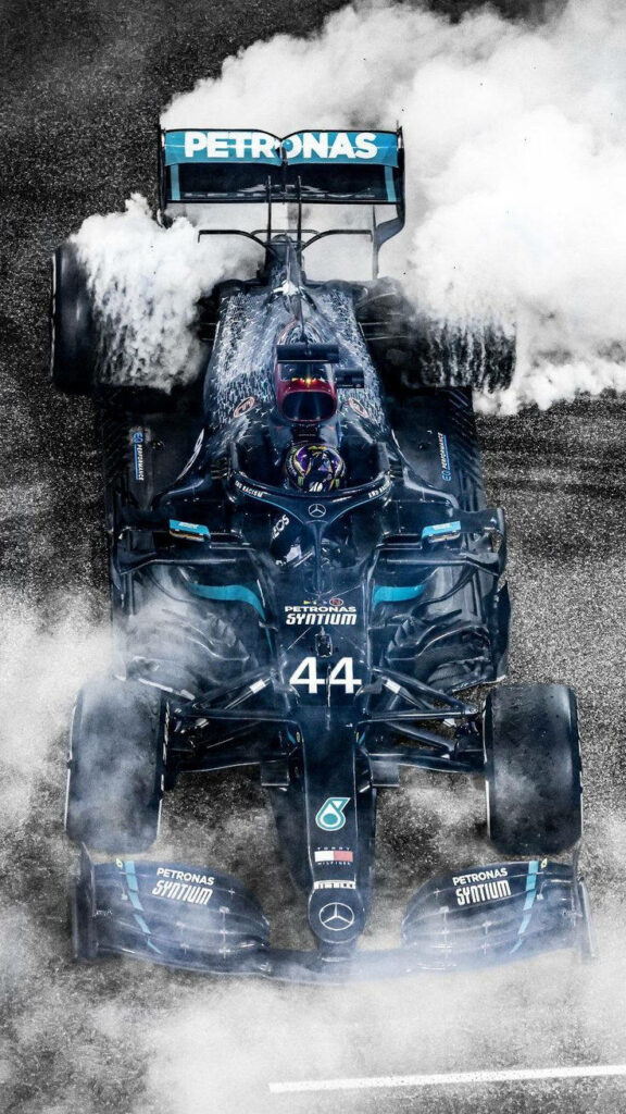 Hamilton F1: Smoke-Enveloped Mercedes Racing Car in Stunning Top View Shot Wallpaper