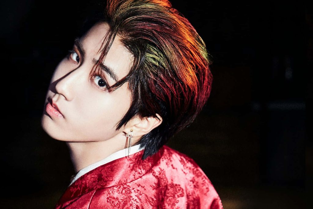 Han Ji-sung Stray Kids close-up portrait with red hair and patterned red outfit on dark background Wallpaper