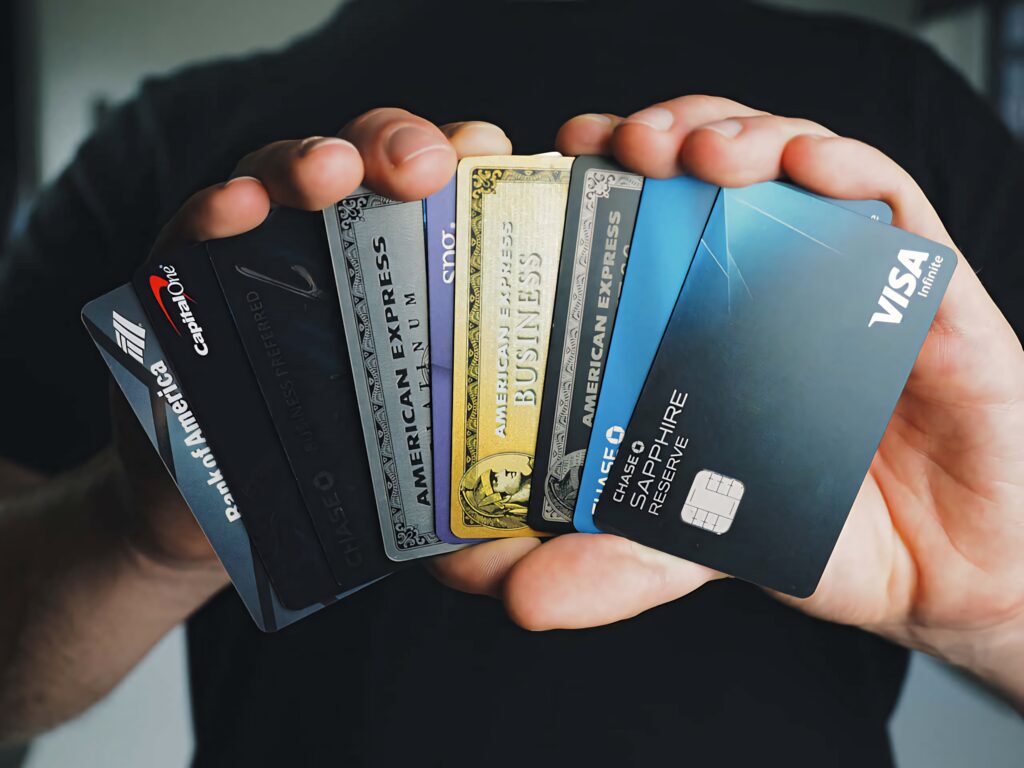Close-up of hand holding major credit cards Visa Amex Capital One Chase Bank of America for secure payments Wallpaper