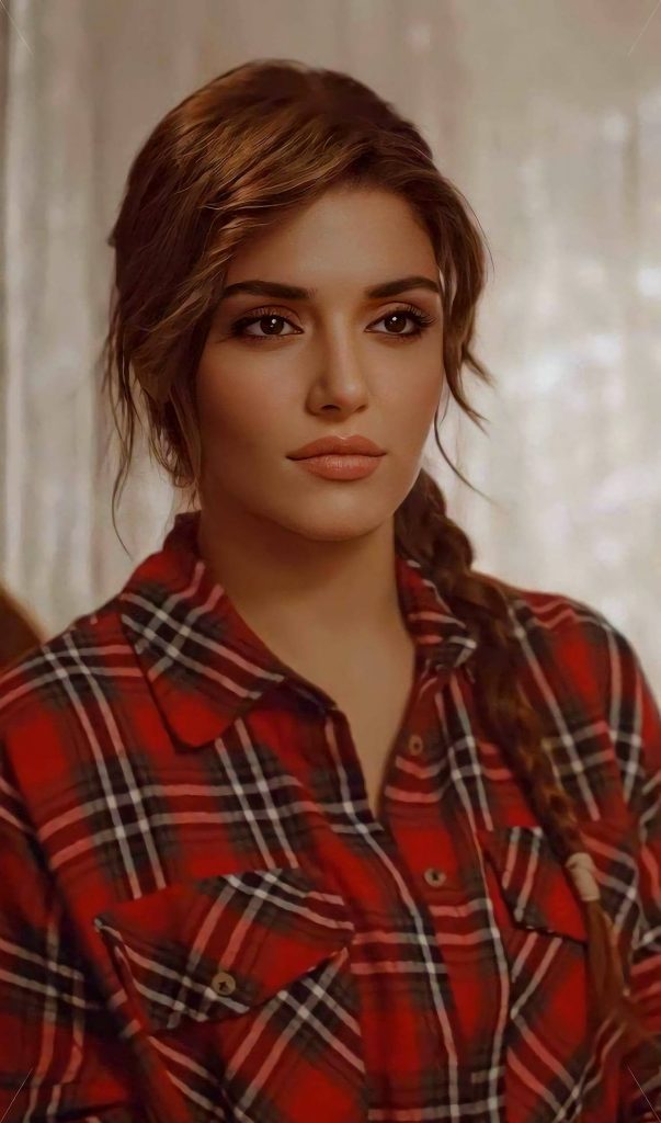 Hande Erçel portrait in cozy red black plaid shirt with soft side-swept hair warmly lit close-up Wallpaper
