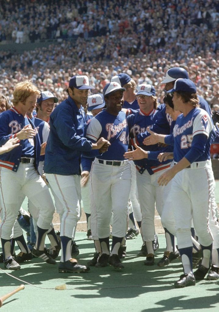 Hank Aaron celebrates home run with teammates in Atlanta Braves jersey number 44 historic photo Wallpaper