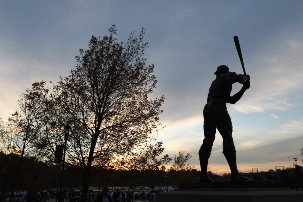 Hank Aaron statue silhouette at sunset striking bronze baseball player wallpaper background