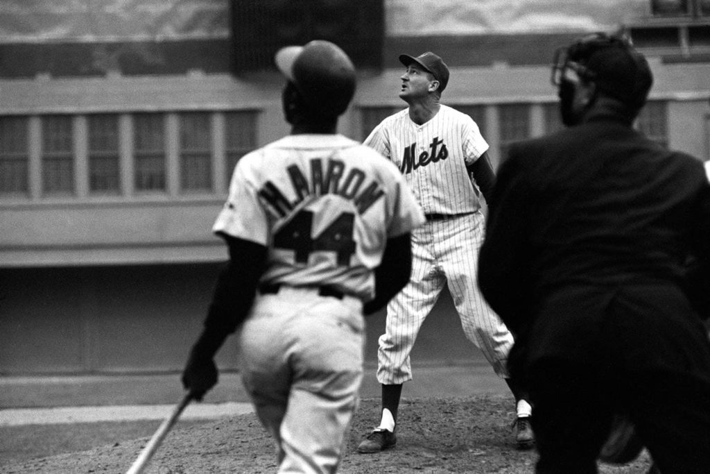 Hank Aaron batting in vintage black and white photo facing New York Mets player number 44 jersey Wallpaper