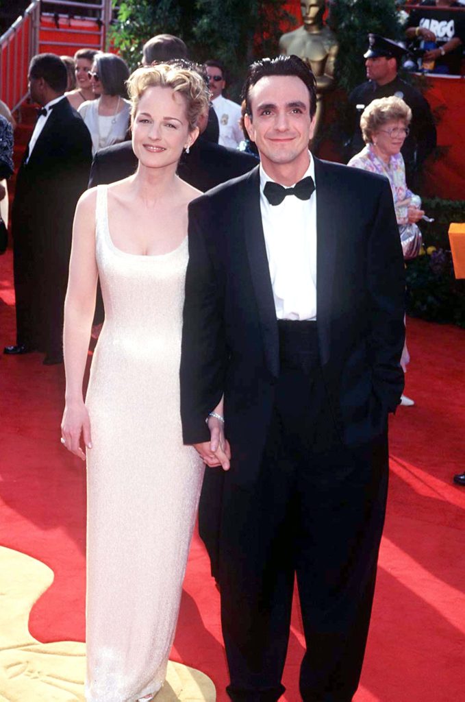 Hank Azaria and Helen Hunt smiling on red carpet at Academy Awards in classic formal wear wallpaper