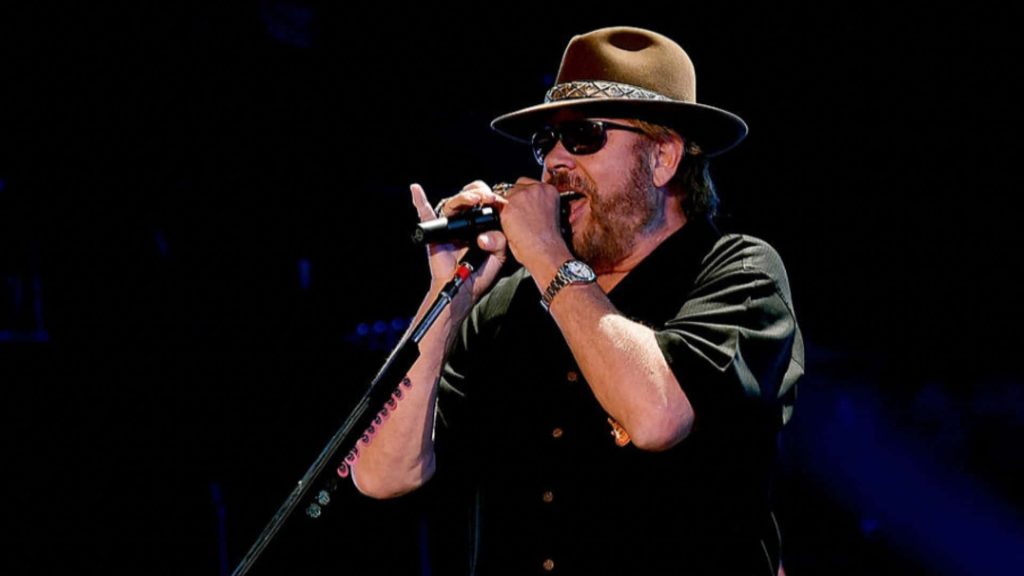 Hank Williams Jr live concert dark moody wallpaper iconic hat sunglasses country music legend