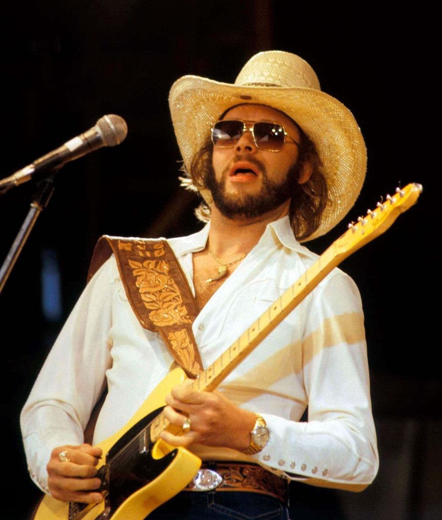 Hank Williams Jr performing live vintage country concert with straw hat aviators guitar wallpaper