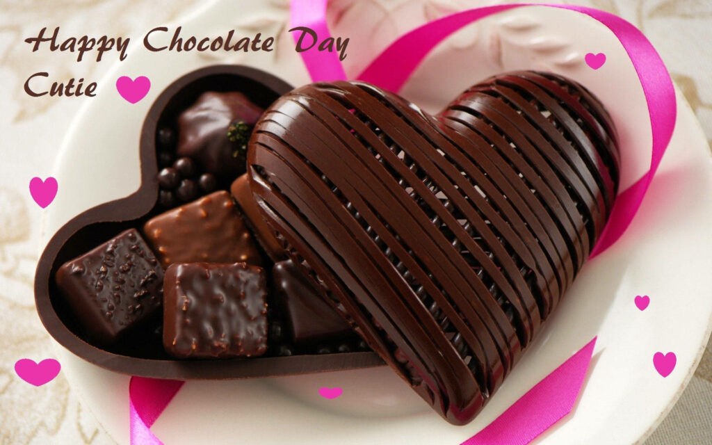 Glossy heart-shaped chocolate box with pink ribbon and hearts Happy Chocolate Day wallpaper background