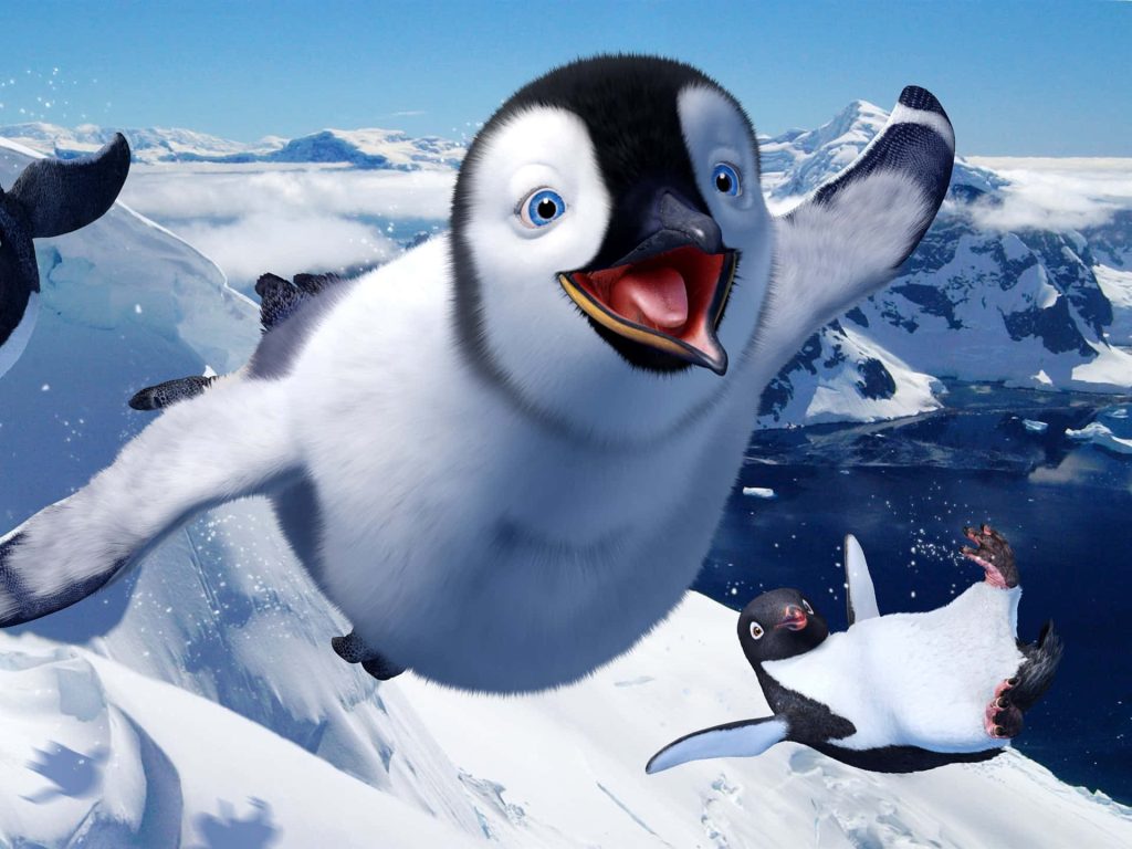 Happy Feet Two wallpaper featuring baby penguin Erik flying over Antarctic snowy peaks and ocean