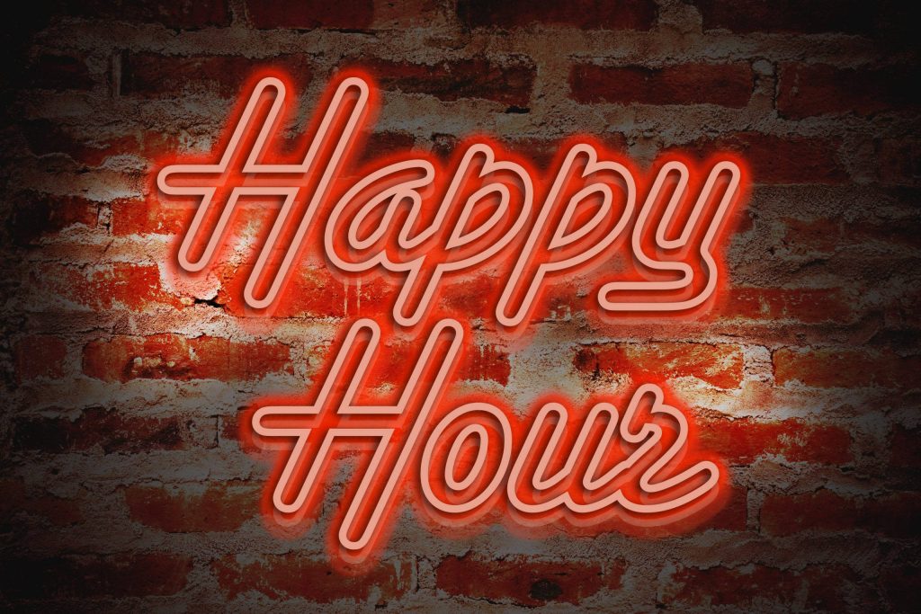 Happy Hour neon sign glowing red on dark brick wall vibrant nightlife wallpaper background