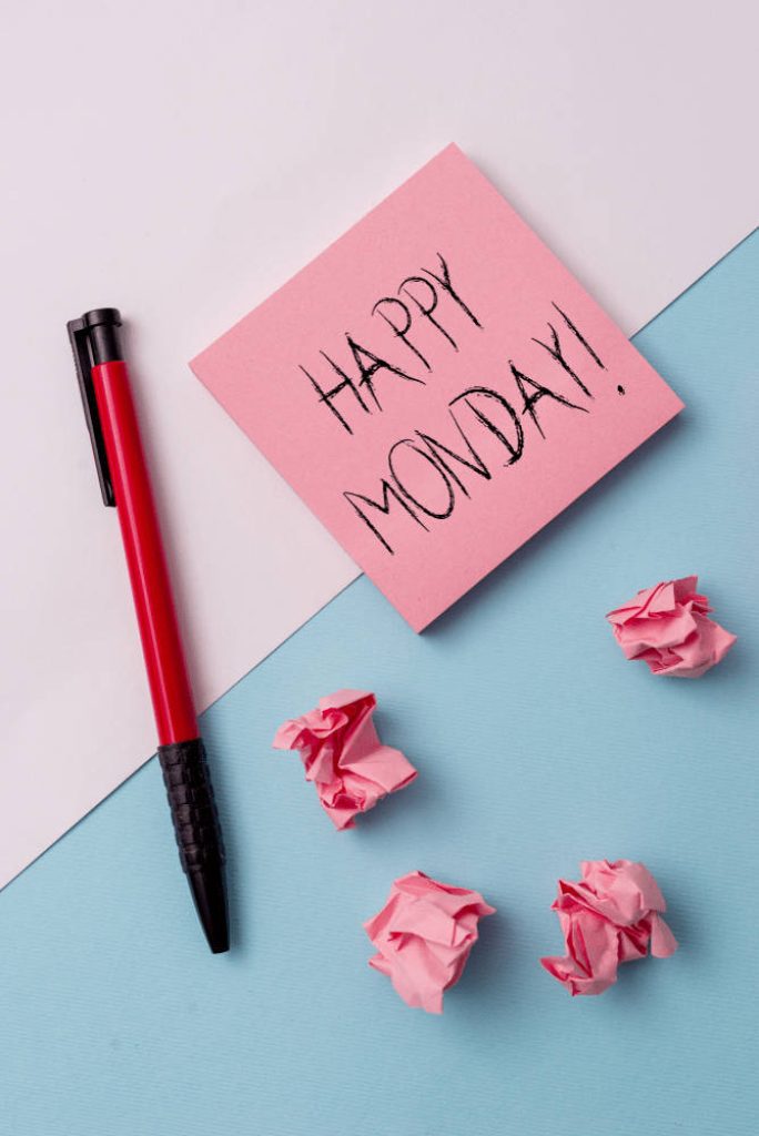 Happy Monday wallpaper with pink sticky note red pen and crumpled paper on blue white background