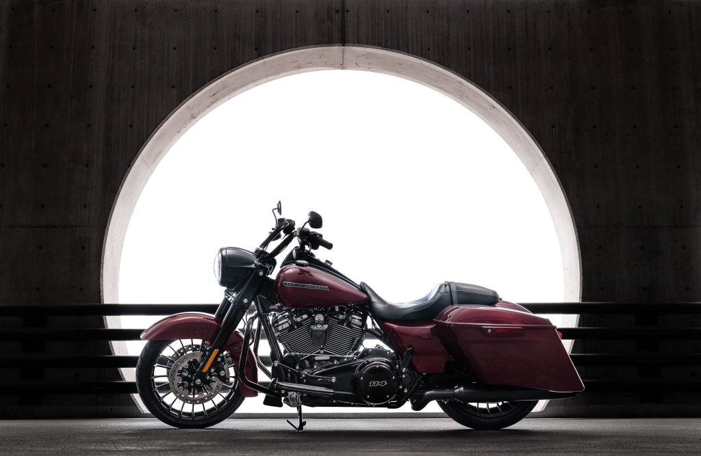 Harley Davidson maroon touring motorcycle with 114 engine framed in bright concrete circle wallpaper