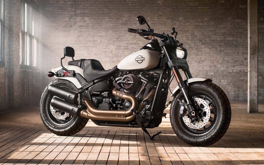 Harley-Davidson Softail Fat Bob matte white tank dual exhaust sunlit industrial loft wallpaper