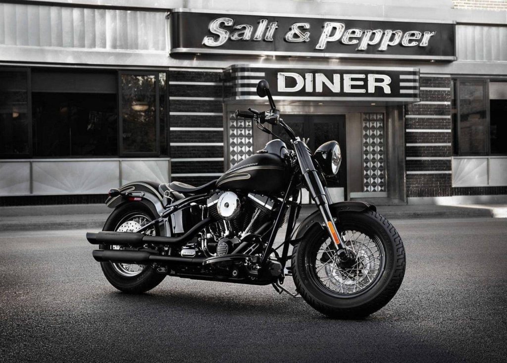 Matte black Harley-Davidson cruiser parked outside retro Salt and Pepper Diner wallpaper background