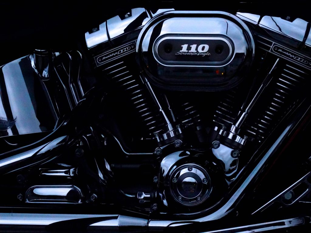 Harley-Davidson Screamin Eagle 110 engine close-up with black chrome design and dramatic lighting Wallpaper