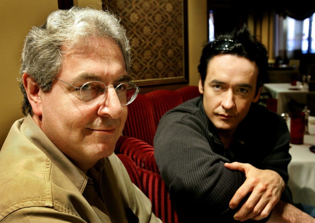 Harold Ramis and John Cusack professional portrait red velvet backdrop warm lighting Wallpaper