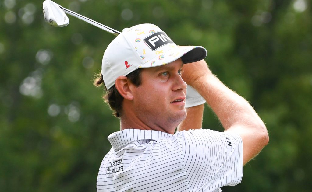 Professional golfer Harris English in striped shirt and PING hat focused mid swing green background Wallpaper