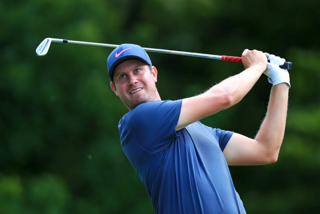 Harris English mid-swing golf wallpaper in blue Nike cap and polo with blurred green background