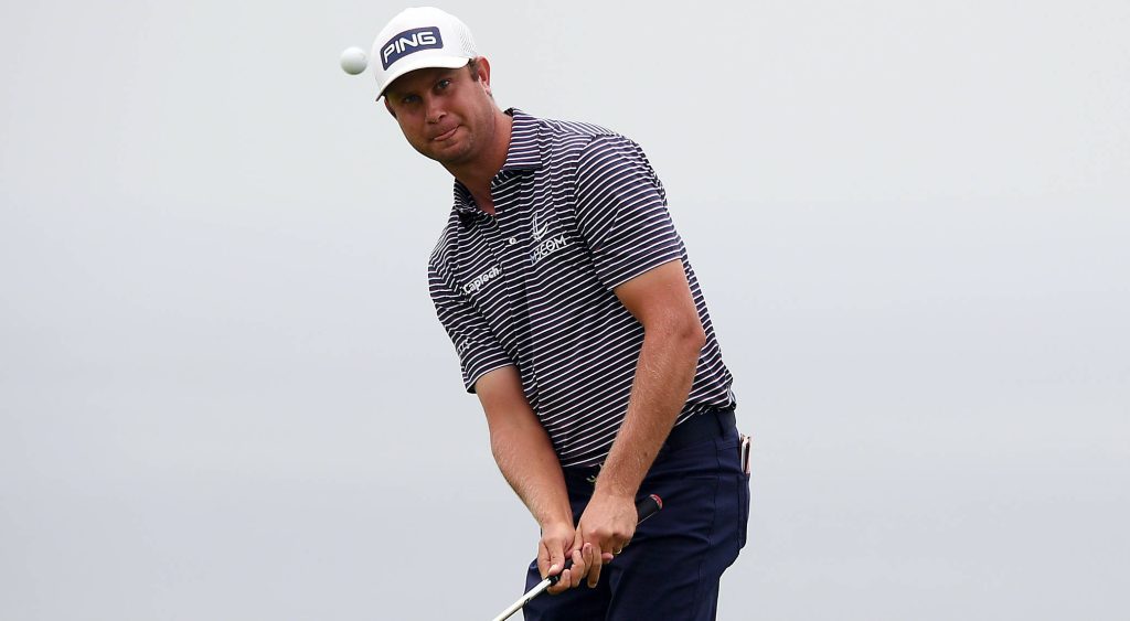 PGA Tour pro Harris English mid-swing tracking golf ball wearing striped polo and PING cap Wallpaper