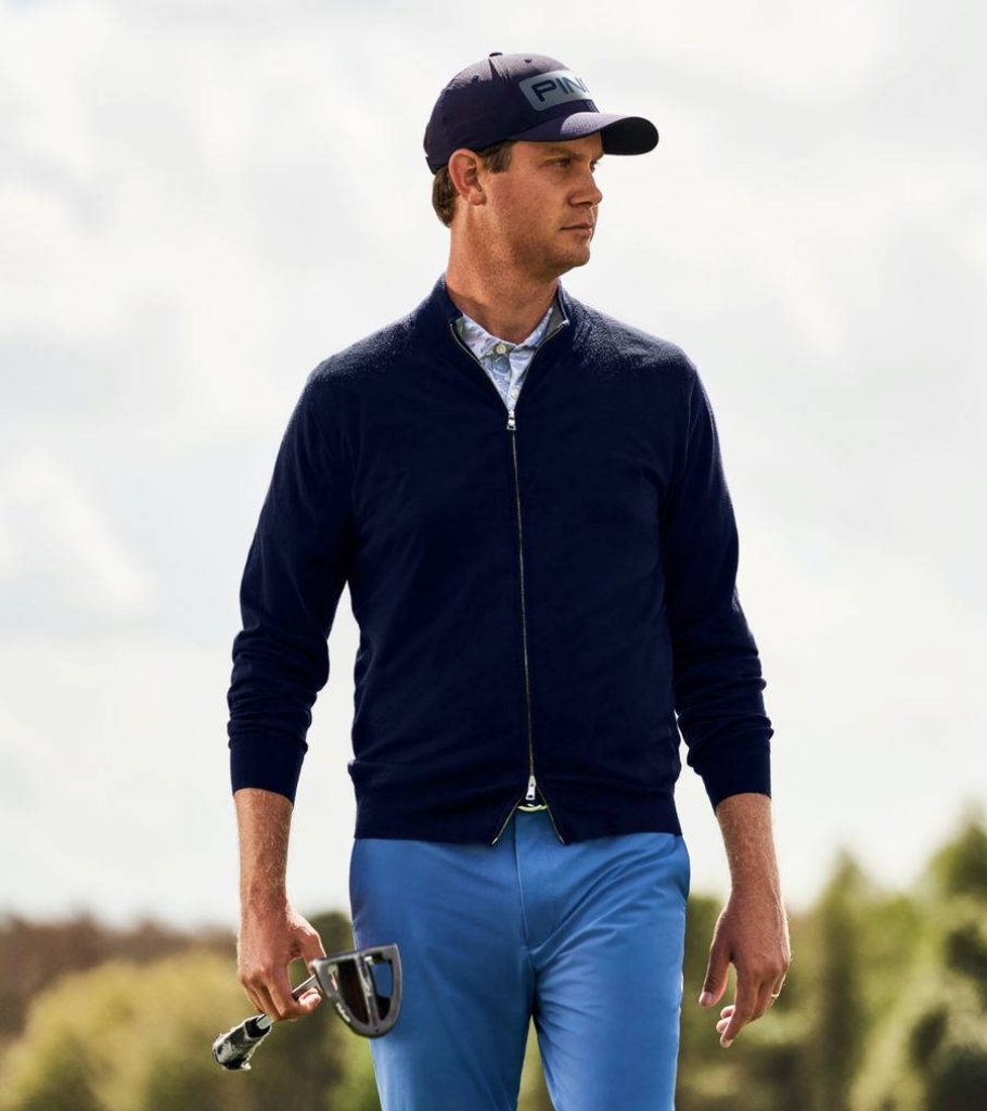 Professional golfer Harris English in navy sweater and PING cap on golf course with club Wallpaper