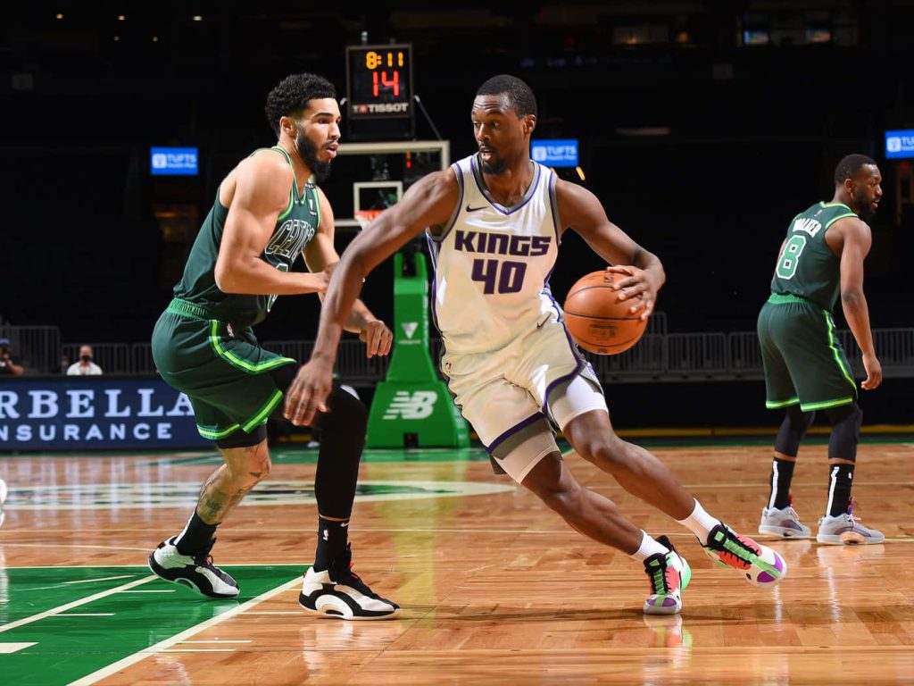 Harrison Barnes drives past Jayson Tatum with Kemba Walker in vibrant NBA game action wallpaper