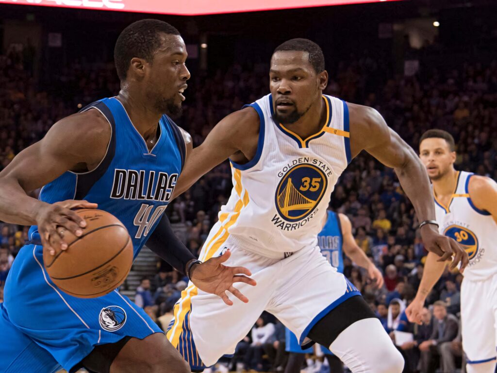 Harrison Barnes drives in Dallas Mavericks blue defended by Kevin Durant Warriors in intense NBA game Wallpaper