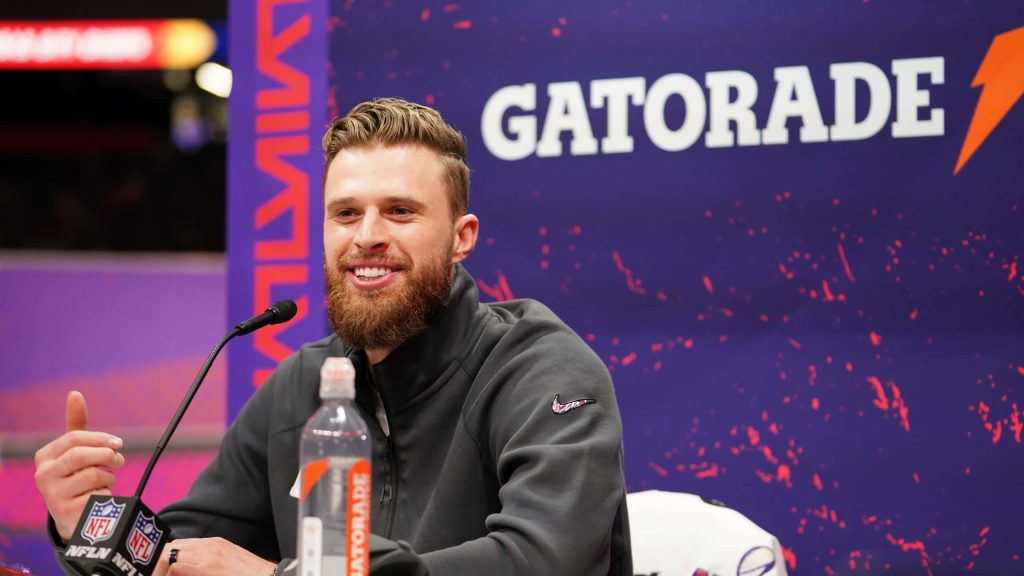 Kansas City Chiefs kicker Harrison Butker smiles in gray Nike jacket at NFL press conference wallpaper
