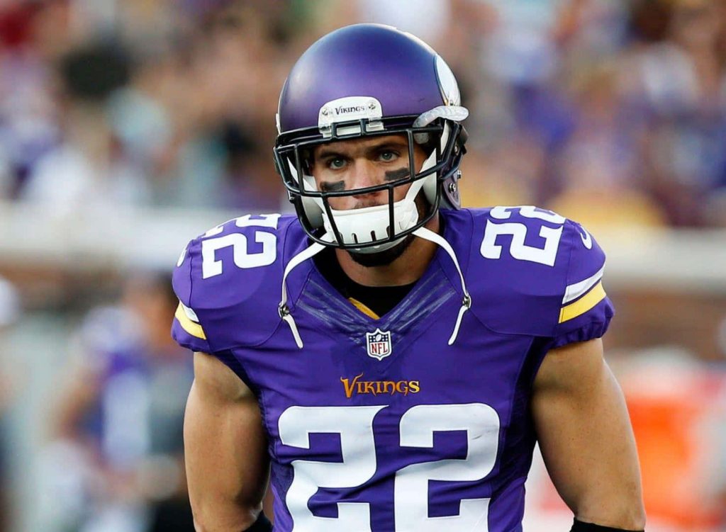 Intense portrait of Minnesota Vikings safety Harrison Smith in purple and gold jersey 22 Wallpaper
