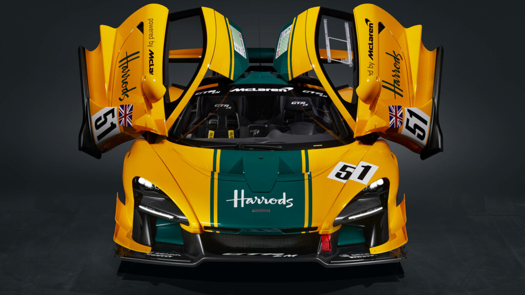 Aerial view of yellow green McLaren Senna with open butterfly doors and racing decals wallpaper