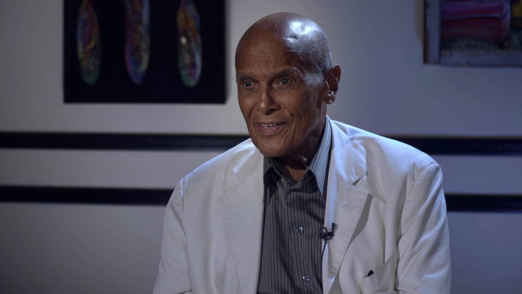 Portrait of Harry Belafonte in white blazer during interview with cool-toned lighting background Wallpaper