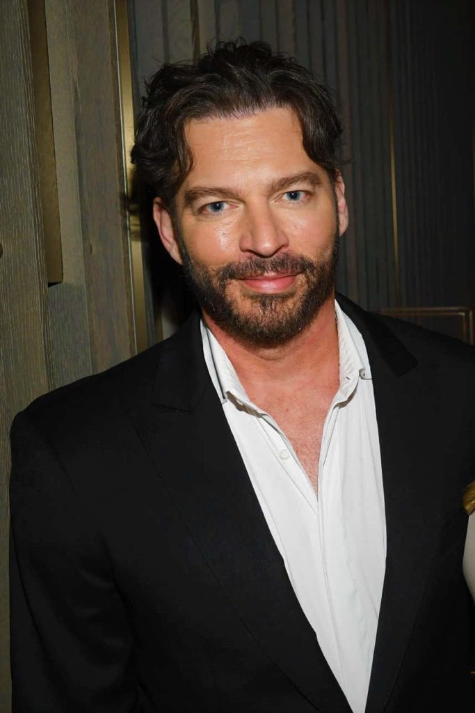 Harry Connick Jr. in black suit at public event with textured wall and soft lighting background Wallpaper